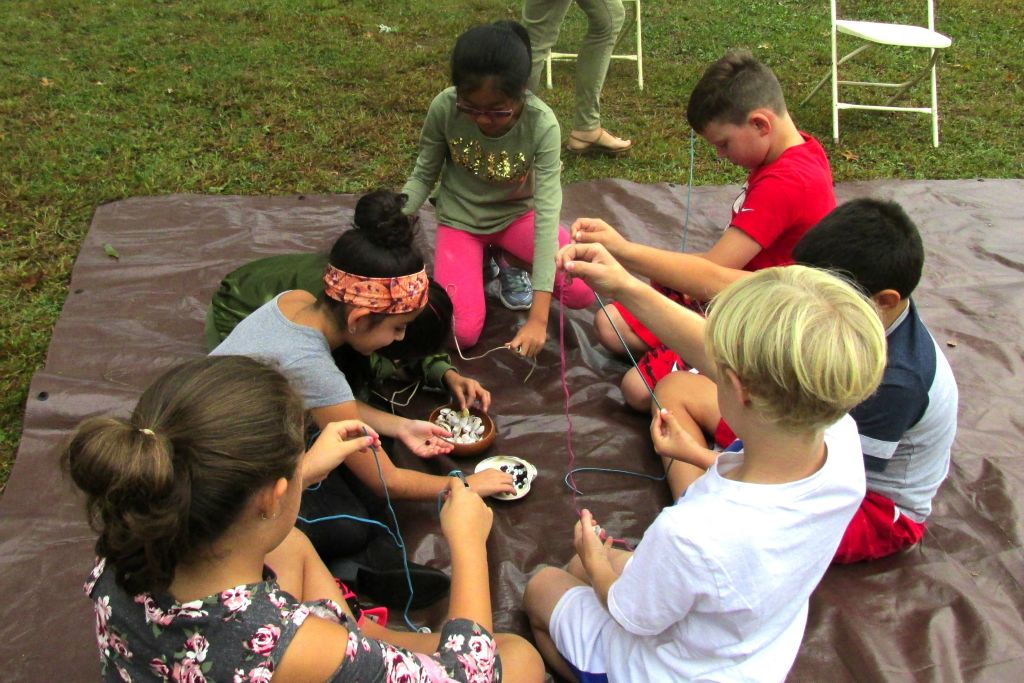 students making necklaces 